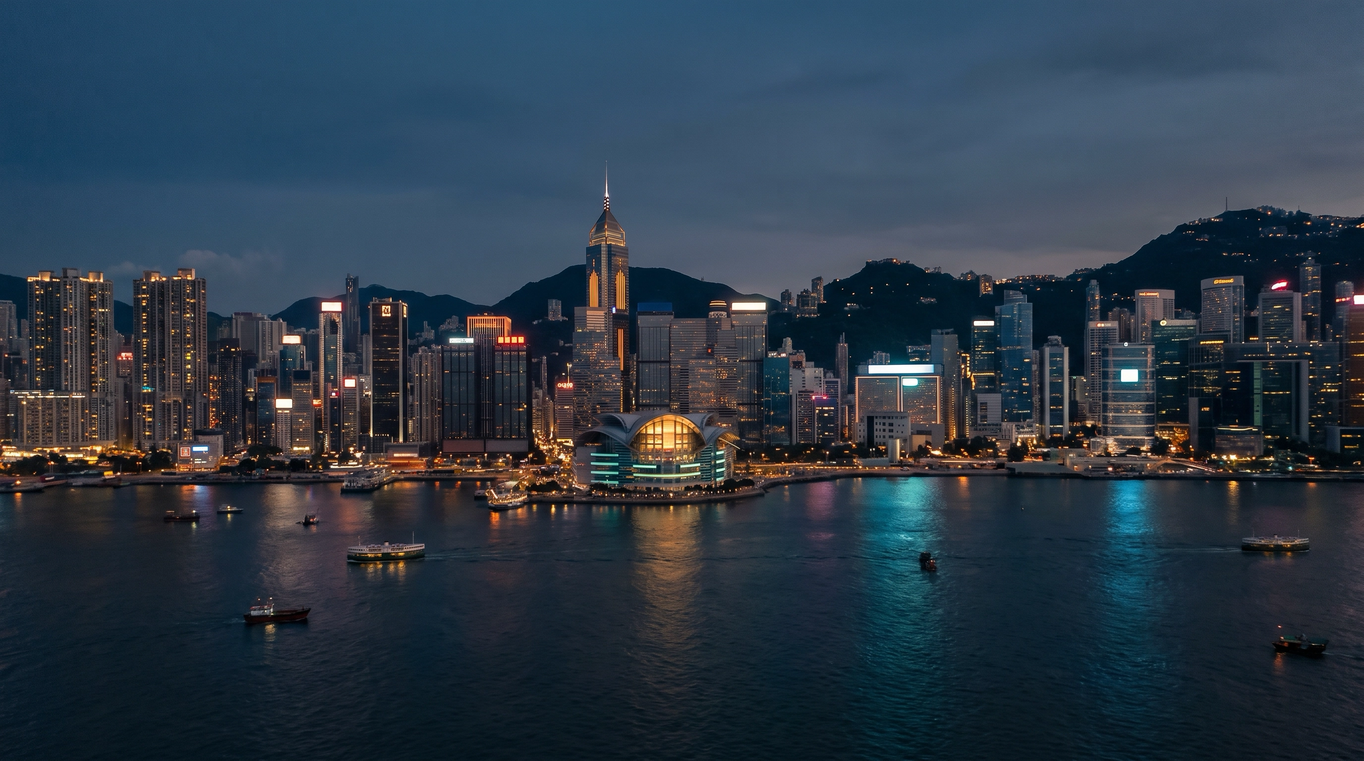 Aerial view of Victoria Harbour and the Hong Kong skyline at dusk